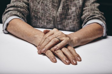 woman with one hand on the other making a decision