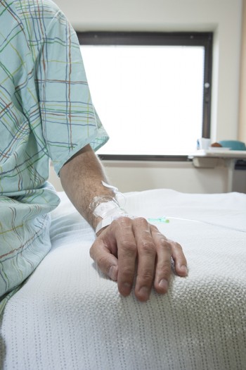 patient hand on hospital bed