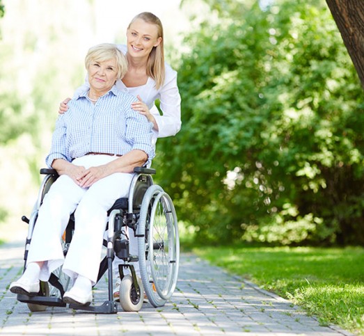 young female with female resident in wheelchair