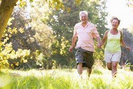 Older couple walking in park