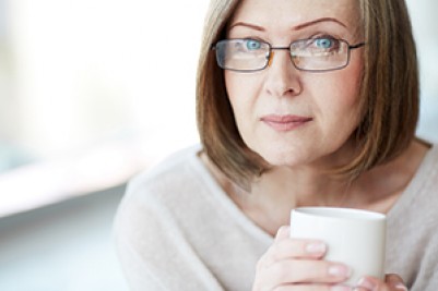 elderly women holding a cup of coffee